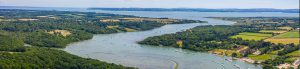 Aerial view of Beaulieu River moorings stretching down to the Solent