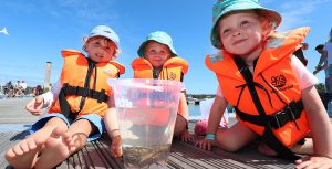 Alistair Harper, Beth and Heidi Lockhart in crabbing competition at the 50th anniversary celebration of Buckler's Hard Yacht Harbour