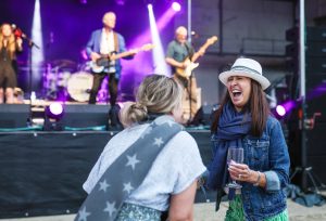 Two mooring holders laughing and dancing in front of the stage